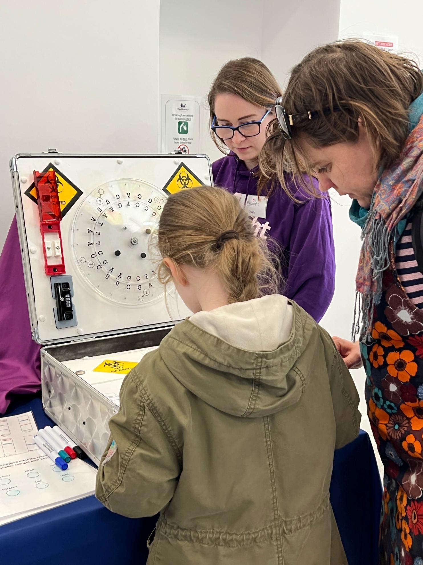 Parent and child completing the Viral Survival containment box