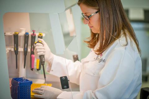 Female scientist pipetting