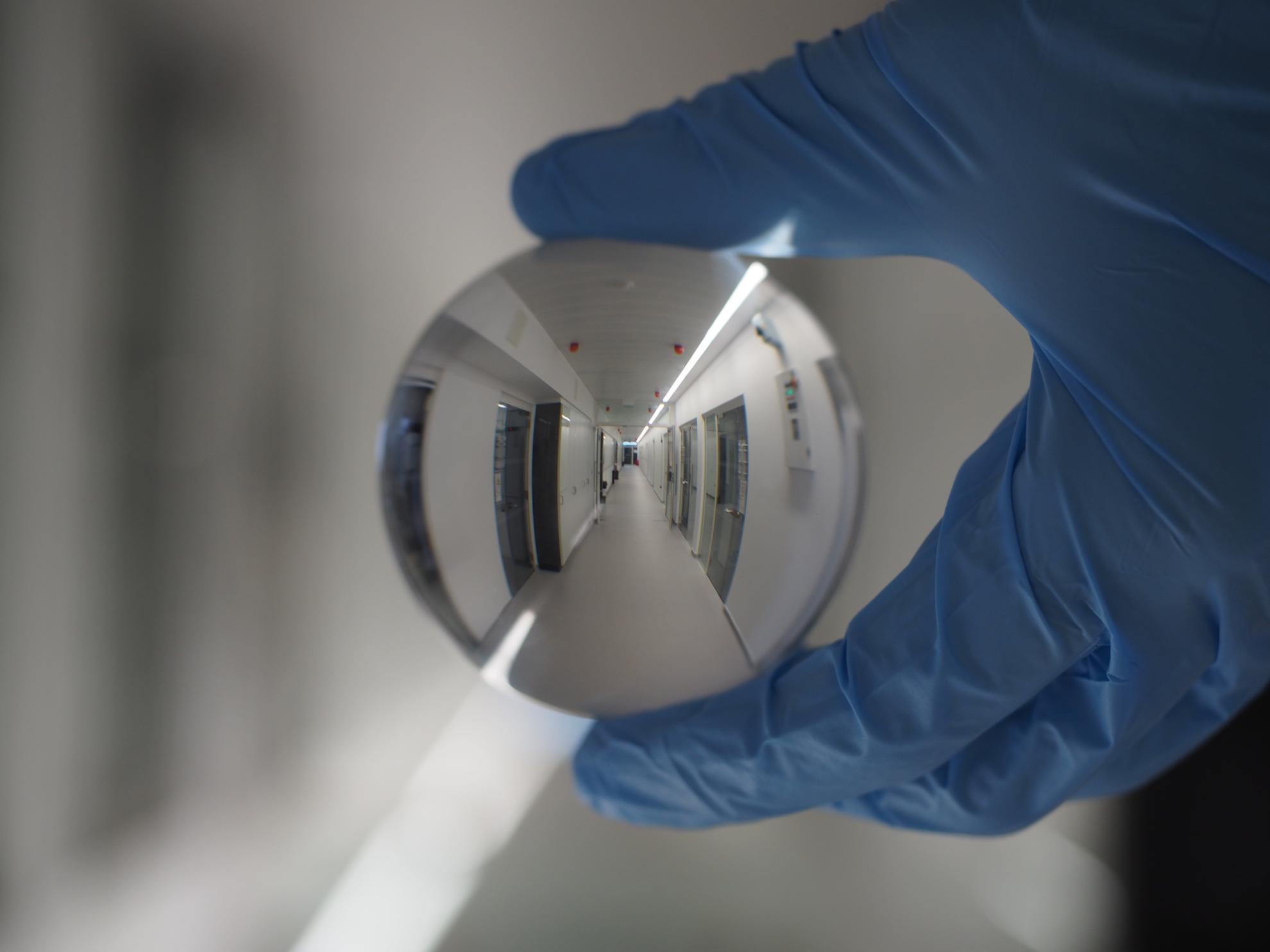 Laboratory corridor magnified through lens ball